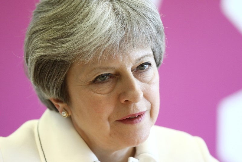 Britain's Prime Minister Theresa May attends a Commonwealth Heads of Government Meeting Youth Forum in London on April 16, 2018. A portrait of British Prime Minister Theresa against a pink background.